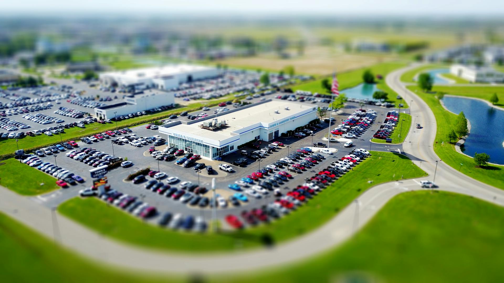 An aeriel view of a generic car dealership representing Expert Auto Exchange.